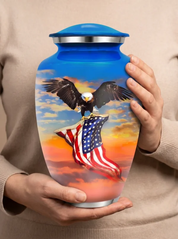 American Eagle Flag cremation urn held for scale