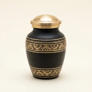 Black and gold hand-engraved small keepsake urn, studio shot
