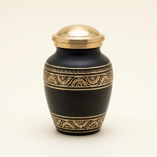 Black and gold hand-engraved small keepsake urn, studio shot