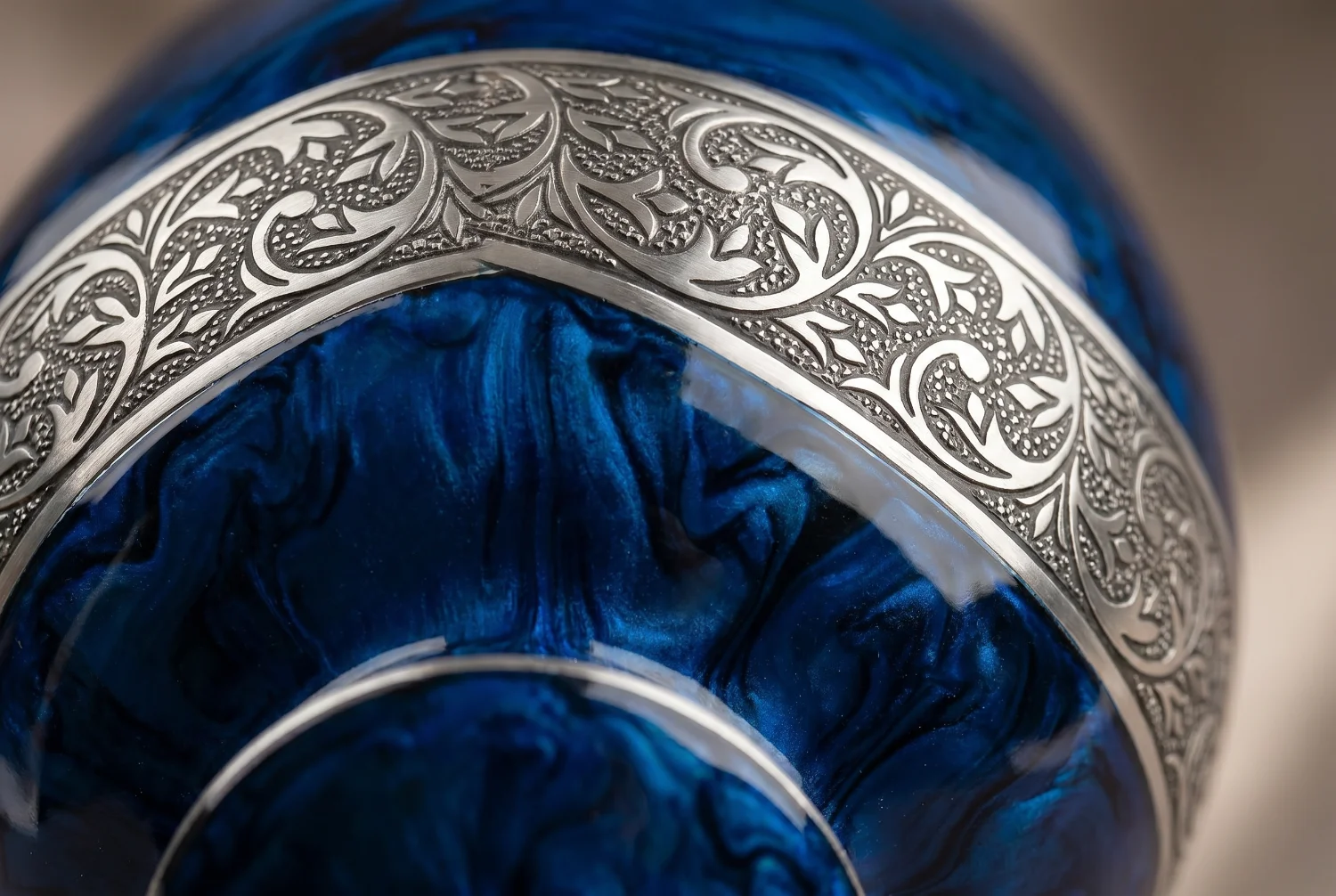 Close-up of the deep blue finish and silver engraved band