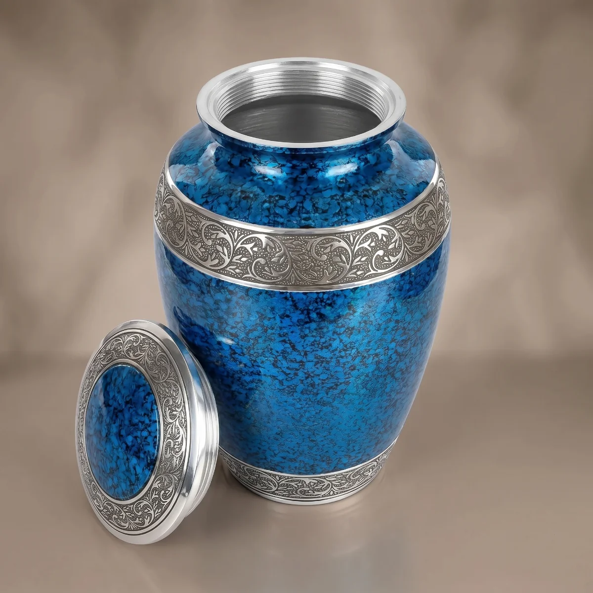 Blue cremation urn with lid off showing the silver screw thread inside the neck