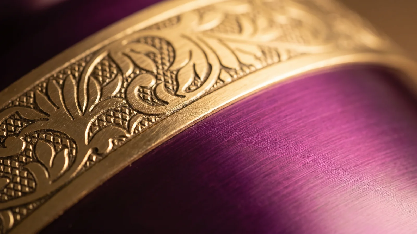 Close-up of the gold engraved band on the plum metallic urn