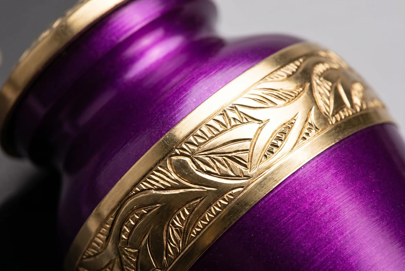 Close-up of the purple finish and gold hand-engraved band