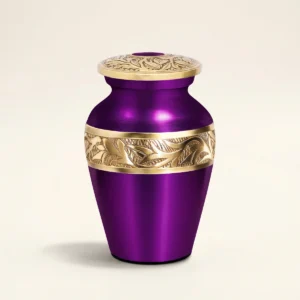 Purple metallic small keepsake urn with gold hand-engraved band, studio shot