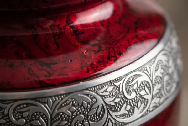 Close-up of the deep red finish and silver engraved band