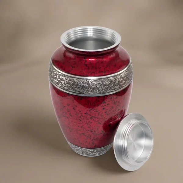 Red cremation urn with lid off showing the silver screw thread inside the neck