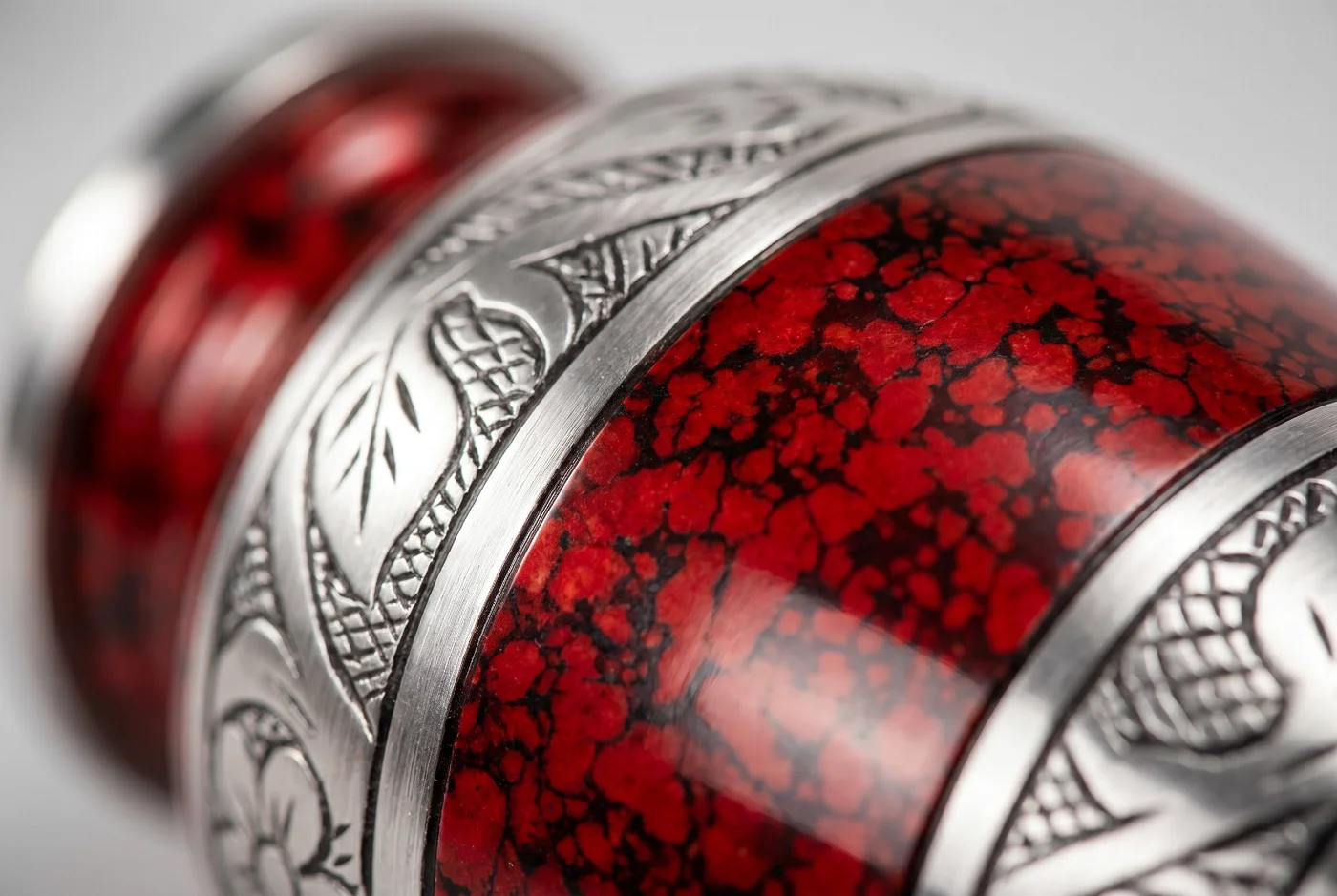 Close-up of the red finish and silver engraved band