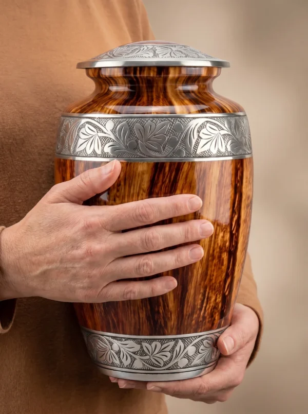Red Oak cremation urn held for scale