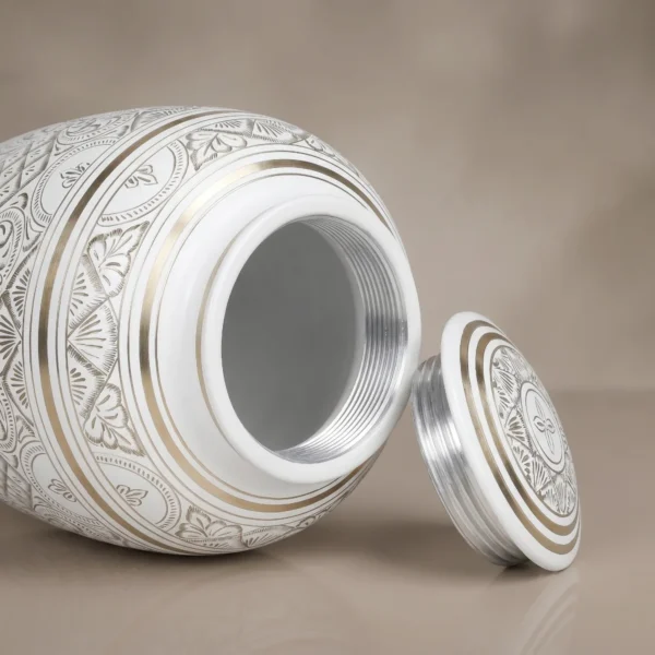 white gold etched cremation urn with lid off showing the silver screw thread inside the neck