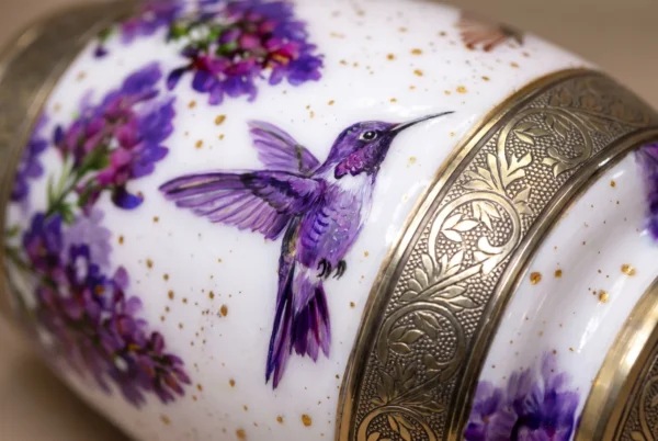 Close-up of the hand-painted hummingbird and silver engraved band