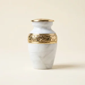 White and gold hand-engraved small keepsake urn, studio shot