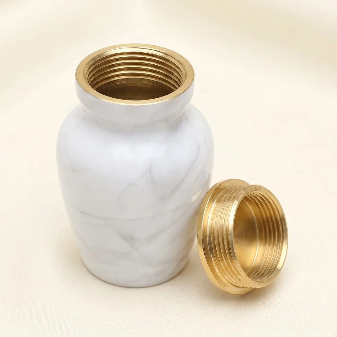 White keepsake urn with the threaded lid removed