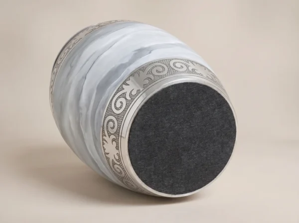white marble cremation urn base with protective charcoal felt bottom