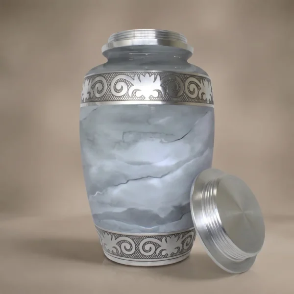 white marble cremation urn with lid off showing the silver screw thread inside the neck
