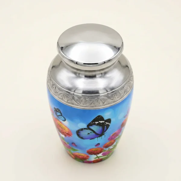 Blue butterfly keepsake urn with a silver engraved band, three-quarter angle