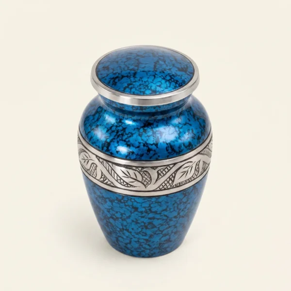 Blue marble keepsake urn with a silver engraved band, three-quarter angle