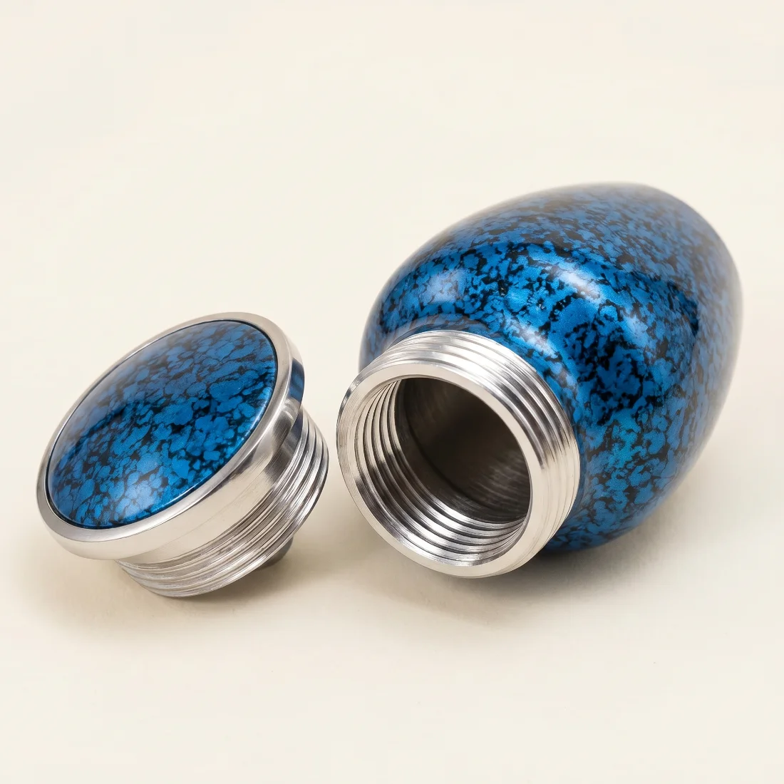 Blue keepsake urn with the silver threaded lid removed