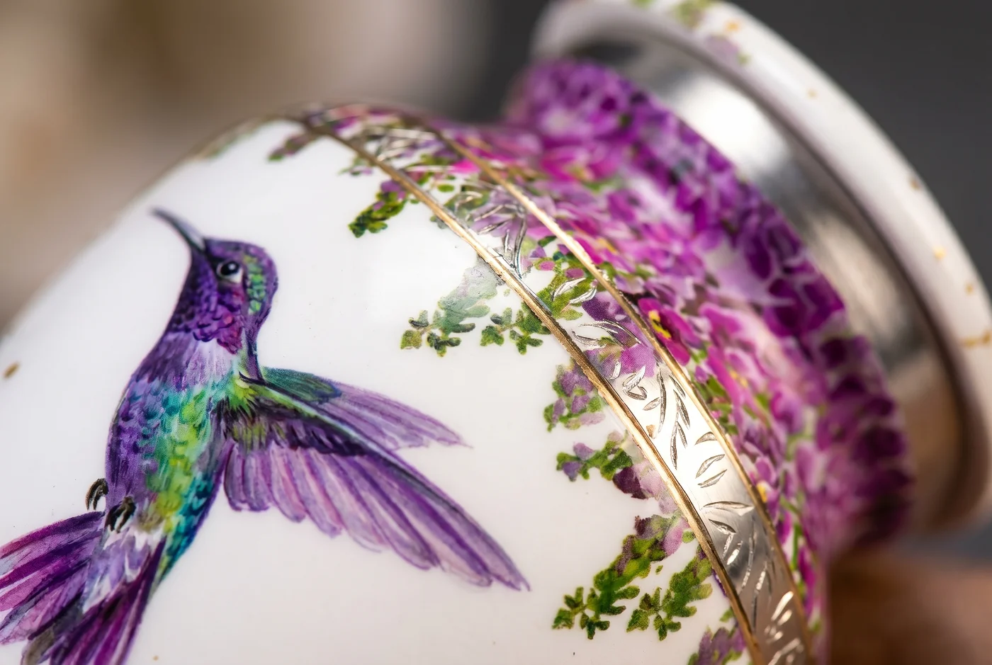 Close-up of the hand-painted hummingbird, purple wisteria flowers and silver engraved band