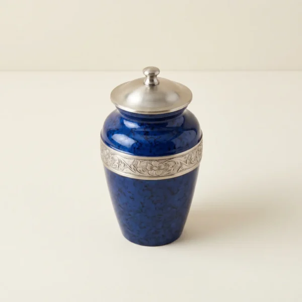 Blue speckled enamel keepsake urn with a silver engraved band, three-quarter angle