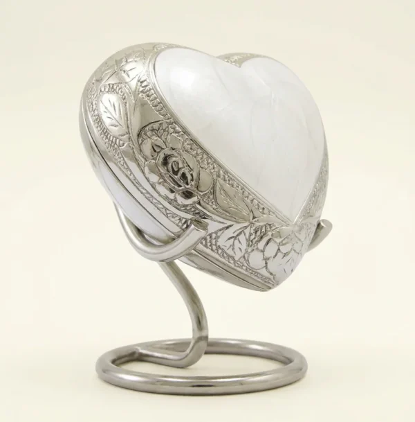 White enamel heart keepsake urn on its stand - three-quarter view