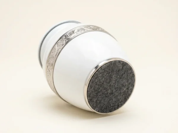 Base of a white enamel keepsake urn with a protective felt bottom