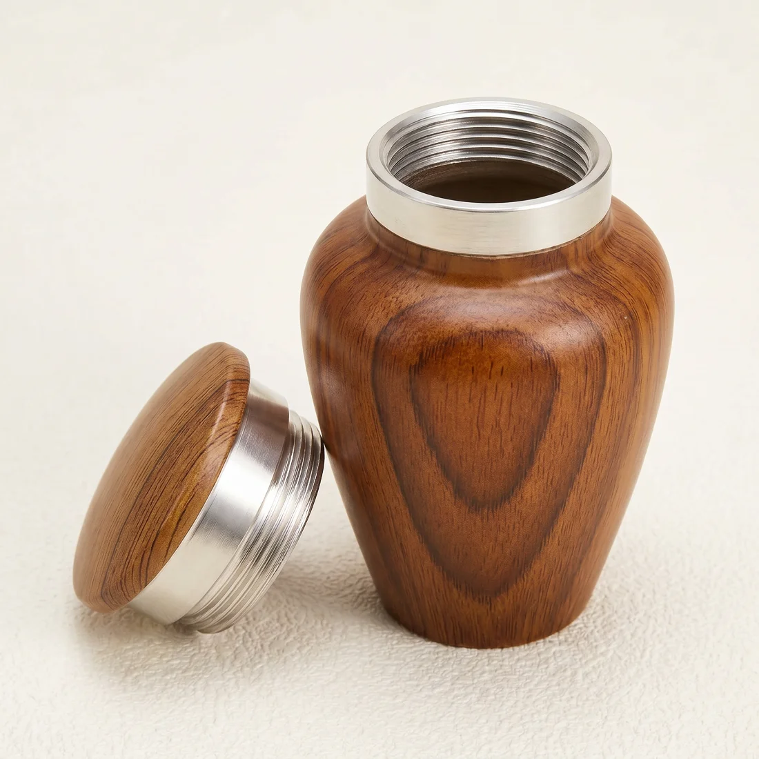 Wood-grain keepsake urn with the silver threaded lid removed